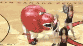 1266235163_raptor_mascot_eats_cheerleader.gif