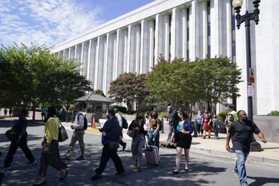 People are evacuated from the James Madison Memorial Building, a Library of Congress building, in Washington on Thursday, Aug. 19, 2021, as law enforcement investigate a report of a pickup truck containing an explosive device near the U.S. Capitol. (AP Photo/Alex Brandon)