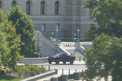A pickup truck is parked on the sidewalk in front of the Library of Congress' Thomas Jefferson Building, as seen from a window of the U.S. Capitol, Thursday, Aug. 19, 2021, in Washington. A man sitting in the pickup truck outside the Library of Congress has told police that he has a bomb, and that's led to a massive law enforcement response to determine whether it's an operable explosive device. (AP Photo/Alex Brandon)